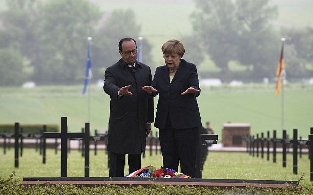 French President Francois Hollande, left, and German Chancellor Angela Merkel gesture after laying a wreath at a German cemetery in Consenvoye, northeastern France, Sunday May 29, 2016, during a remembrance ceremony to mark the centenary of the battle of Verdun. (Jean Christophe Verhaegen/Pool via AP)