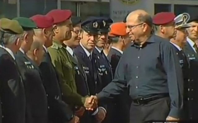 Outgoing Defense Minister Moshe Ya'alon shakes hands with IDF top brass during a departure ceremony at the Kiyra military compound in Tel Aviv on May 22, 2016 (screen capture: Channel 2)