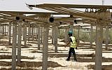 A worker walking past some of the 55,000 mirrors directing sunlight toward the Ashalim solar tower during construction, near the southern Israeli kibbutz of Ashalim in the Negev desert, May 26, 2016. (Jack Guez/AFP)