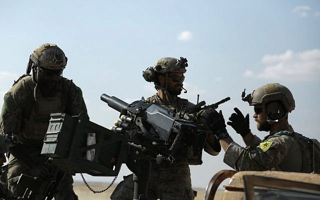 This file photo taken on May 25, 2016 shows men in uniform identified by Syrian Democratic forces as US special operations forces as they ride in the back of a pickup truck in the village of Fatisah in the northern Syrian province of Raqqa. (AFP Photo/Delil Souleiman)