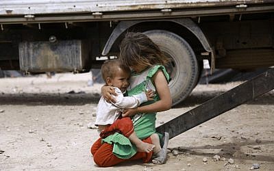 Iraqi children who fled with their family the northern province of Nineveh following the advance of jihadists of the Islamic State group, are seen in a refugee camp in al-Hawl located some 14 kilometers from the Iraqi border in Syria's northeastern Hassakeh province, on May 31, 2016.(AFP/DELIL SOULEIMAN)