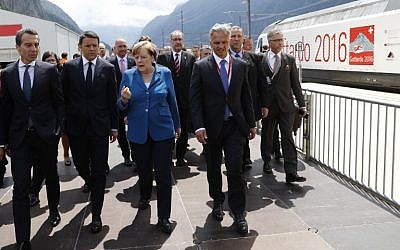 German Chancellor Angela Merkel, center, speaks with Austrian Chancellor Christian Kern, left, Italian Prime Minister Matteo Renzi, second left, and Swiss Federal Councillor Didier Burkhalter, second right, on the opening day of the Gotthard Rail Tunnel in Erstfeld on June 1, 2016. (AFP/Peter Klaunzer/Pool)