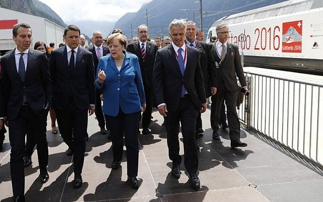 German Chancellor Angela Merkel, center, speaks with Austrian Chancellor Christian Kern, left, Italian Prime Minister Matteo Renzi, second left, and Swiss Federal Councillor Didier Burkhalter, second right, on the opening day of the Gotthard Rail Tunnel in Erstfeld on June 1, 2016. (AFP/Peter Klaunzer/Pool) German Chancellor Angela Merkel, center, speaks with Austrian Chancellor Christian Kern, left, Italian Prime Minister Matteo Renzi, second left, and Swiss Federal Councillor Didier Burkhalter, second right, on the opening day of the Gotthard Rail Tunnel in Erstfeld on June 1, 2016. (AFP/Peter Klaunzer/Pool)