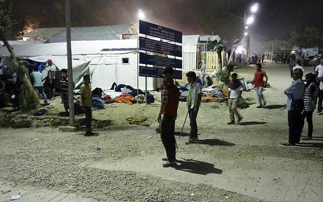 Migrants gather during overnight clashes at the Moria detention camp on the island of Lesbos, Greece, early on June 2, 2016. (STR/AFP)