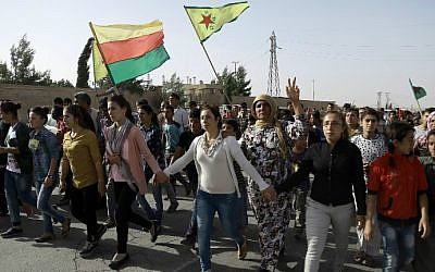Syrian Kurds march during the funeral of fighters who died during an assault launched by Arab and Kurdish forces against the Islamic State (IS) group in the town of Manbij, in the Syrian Kurdish town of Kobane on June 4, 2016. (Delil Souleiman/AFP) Syrian Kurds march during the funeral of fighters who died during an assault launched by Arab and Kurdish forces against the Islamic State (IS) group in the town of Manbij, in the Syrian Kurdish town of Kobane on June 4, 2016. (Delil Souleiman/AFP)