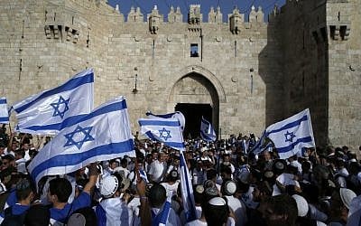 Israelis wave national flags as they take part in an annual march marking Israel's 1967 capture and subsequent annexation of the eastern half of Jerusalem, outside Damascus Gate in Jerusalem's Old City on June 5, 2016. (AFP PHOTO / AHMAD GHARABLI) Israelis wave national flags as they take part in an annual march marking Israel's 1967 capture and subsequent annexation of the eastern half of Jerusalem, outside Damascus Gate in Jerusalem's Old City on June 5, 2016. (AFP PHOTO / AHMAD GHARABLI)