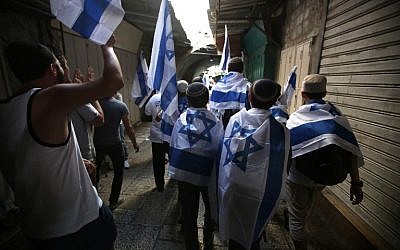 Young Jewish Israelis march through the Muslim Quarter of the Old City on their way to the Western Wall to celebrate Jerusalem Day on June 05, 2016. (Menahem Kahana/AFP)