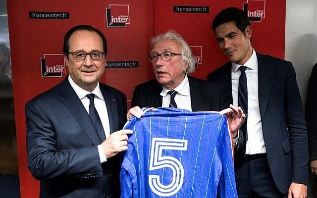 French President Francois Hollande poses after receiving the jersey of former French soccer player Marius Tresor following the France Inter's radio program 'L'Oeil du Tigre' (The Eye of the Tiger) at the Radio France headquarters in Paris, June 5, 2016. (AFP Photo/Pool/Etienne Laurent)