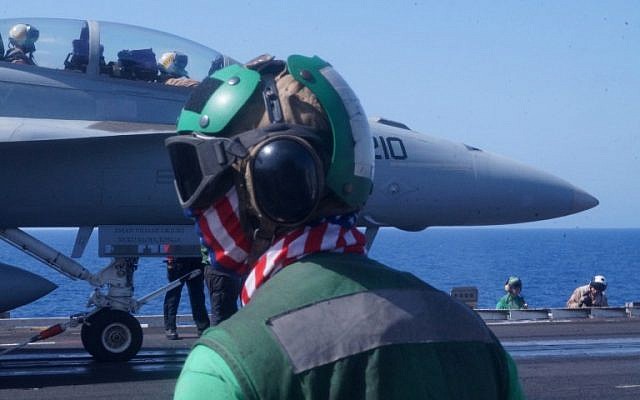 US Navy sailors prepare to catapult launch a fighter jet from the deck of the USS Harry S. Truman aircraft carrier in the Eastern Mediterranean on June 7, 2016. US planes operating from an aircraft carrier in the eastern Mediterranean have mounted at least 35 air strikes on Islamic State jihadists since relocating last week from the Gulf, officers on board told AFP on JUne 7, 2016. (AFP PHOTO / Angus MACKINNON) US Navy sailors prepare to catapult launch a fighter jet from the deck of the USS Harry S. Truman aircraft carrier in the Eastern Mediterranean on June 7, 2016. US planes operating from an aircraft carrier in the eastern Mediterranean have mounted at least 35 air strikes on Islamic State jihadists since relocating last week from the Gulf, officers on board told AFP on JUne 7, 2016. (AFP PHOTO / Angus MACKINNON)