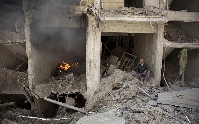 A man sits on the rubble of a destroyed building following reported air strikes by Syrian government forces in the rebel-held Shaar neighborhood of the northern city Aleppo, June 8, 2016. (AFP/KARAM AL-MASRI) A man sits on the rubble of a destroyed building following reported air strikes by Syrian government forces in the rebel-held Shaar neighborhood of the northern city Aleppo, June 8, 2016. (AFP/KARAM AL-MASRI)