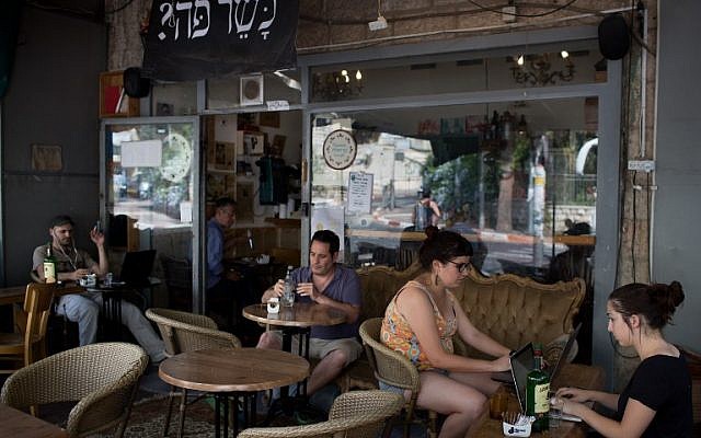 Customers sit at the Carousela restaurant, which was supervised by Hashgaha Pratit - Hebrew for private supervision - to check it abides by kosher practices, on June 8, 2016, in Jerusalem's Rehavia neighborhood.(AFP PHOTO / MENAHEM KAHANA)