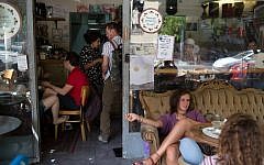 Customers sit at the Carousela restaurant, which was supervised by Hashgaha Pratit - Hebrew for private supervision - to check it abides by kosher practices, on June 8, 2016, in Jerusalem's Rehavia neighborhood.(AFP PHOTO / MENAHEM KAHANA)