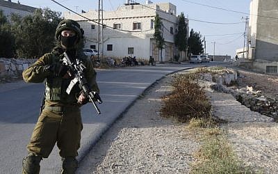 An Israel soldier at the entrance of the Palestinian town of Yatta in the West Bank on June 9, 2016. (AFP/HAZEM BADE)
