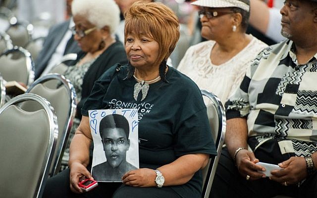 A woman holds a portrait of Muhammad Ali during an Islamic Janazah service for him at Freedom Hall on June 9, 2016 in Louisville, Kentucky. (AFP PHOTO / Michael B. Thomas)
