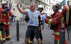 An injured English supporter is helped by a rescue team after a street brawl ahead of the England-Russia Euro 2016 soccer match om Marseille on June 11, 2016. (AFP PHOTO/JEAN CHRISTOPHE MAGNENET)