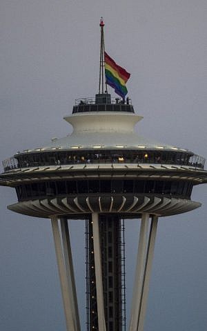 A rainbow flag flies at half mast on the Space Needle in Seattle, Washington on June 12, 2016, in honor of the victims of the nightclub shooting in Orlando.(AFP PHOTO / OMAR TORRES)