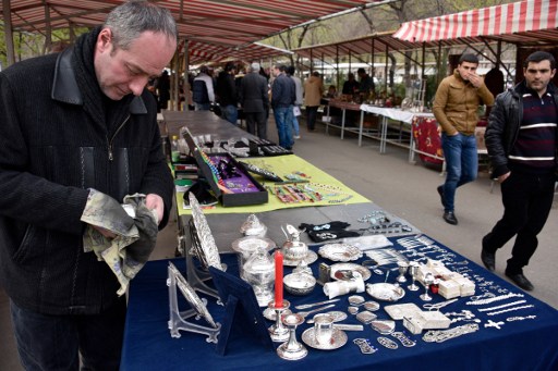 A picture taken on March 31, 2016 shows Syrian Armenian silversmith Levon Keoshkerian, 47, who came from Aleppo to the Armenian capital in 2015, displaying handicrafts on sale at an outdoor flea market in Yerevan. (AFP PHOTO / KAREN MINASYAN) A picture taken on March 31, 2016 shows Syrian Armenian silversmith Levon Keoshkerian, 47, who came from Aleppo to the Armenian capital in 2015, displaying handicrafts on sale at an outdoor flea market in Yerevan. (AFP PHOTO / KAREN MINASYAN)