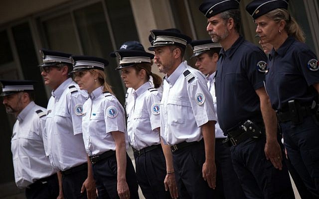 French police officers observe a minute of silence during a ceremony in memory of a French police officer and his partner, killed on June 13 by a man claiming allegiance to the Islamic State group, at the Eveche police station in Marseille on June 16, 2016. / AFP PHOTO / BERTRAND LANGLOIS