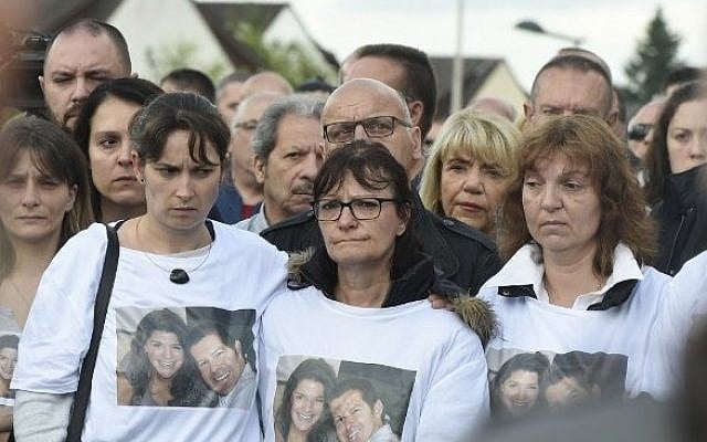 People gather outside the victims' house during a march in the Paris suburb of Magnanville, on June 16, 2016, in tribute to French policeman Jean-Baptiste Salvaing and his partner Jessica Schneider killed outside their home in Magnanville. (AFP / DOMINIQUE FAGET) People gather outside the victims' house during a march in the Paris suburb of Magnanville, on June 16, 2016, in tribute to French policeman Jean-Baptiste Salvaing and his partner Jessica Schneider killed outside their home in Magnanville. (AFP / DOMINIQUE FAGET)