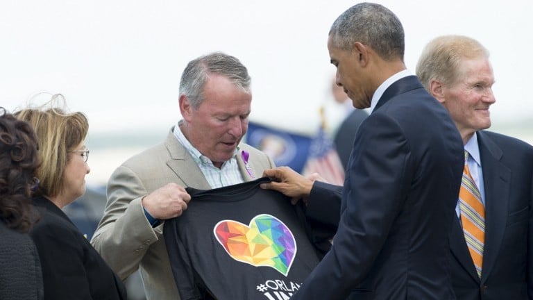 Orlando Mayor Buddy Dyer (L) holds an "Orlando United" T-shirt while greeting US President Barack Obama atthe Orlando International Airport in Orlando, Florida, June 16, 2016. (AFP PHOTO / SAUL LOEB) Orlando Mayor Buddy Dyer (L) holds an "Orlando United" T-shirt while greeting US President Barack Obama atthe Orlando International Airport in Orlando, Florida, June 16, 2016. (AFP PHOTO / SAUL LOEB)