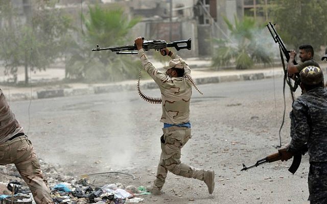 Iraqi government forces clash with Islamic State (IS) group fighters in Fallujah on June 18, 2016 as they hunt down holdout jihadists after retaking the city which was IS's last remaining major hub in Iraq. (Stringer/AFP)