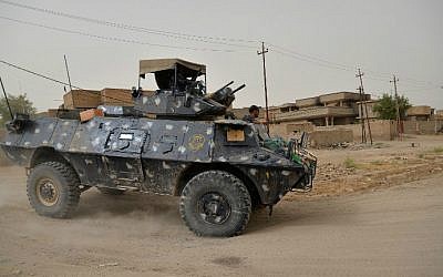 Iraqi government forces patrol the center of the city of Fallujah on June 18, 2016 as they hunt down holdout jihadists after retaking the Islamic State (IS) group's last remaining major hub in Iraq. (Stringer/AFP)