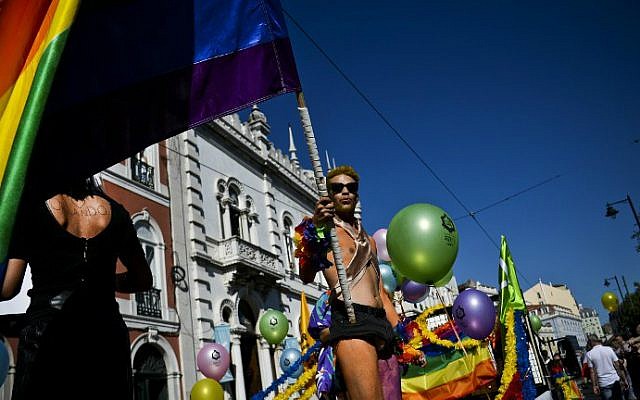 A man waves a giant rainbow flag as he dances during the Gay Pride Parade in Lisbon, Portugal, on June 18, 2016. (Patricia de Melo Moreira/AFP) A man waves a giant rainbow flag as he dances during the Gay Pride Parade in Lisbon, Portugal, on June 18, 2016. (Patricia de Melo Moreira/AFP)