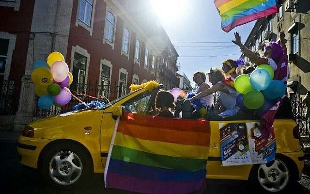 A car passes with people holding balloons and rainbow flags during the Gay Pride Parade in Lisbon, Portugal, on June 18, 2016. (Patricia de Melo Moreira/AFP) A car passes with people holding balloons and rainbow flags during the Gay Pride Parade in Lisbon, Portugal, on June 18, 2016. (Patricia de Melo Moreira/AFP)