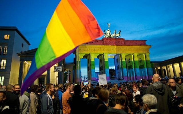 People gather in front of the Brandenburg Gate, illuminated in rainbow colors, to pay tribute to the victims of the Orlando killing, in Berlin, Germany, on June 18, 2016. (Jörg Carstensen/dpa/AFP) People gather in front of the Brandenburg Gate, illuminated in rainbow colors, to pay tribute to the victims of the Orlando killing, in Berlin, Germany, on June 18, 2016. (Jörg Carstensen/dpa/AFP)