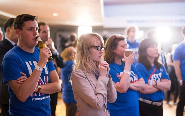 Supporters of the 'Stronger In' Campaign watch the results of the EU referendum being announced at a results party at the Royal Festival Hall in London on June 24, 2016.(AFP PHOTO / POOL / ROB STOTHARD)