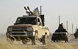 US-backed Kurdish and Arab fighters advance into the Islamic State's bastion of Manbij, in northern Syria, on June 23, 2016. (AFP/Delil Souleiman)