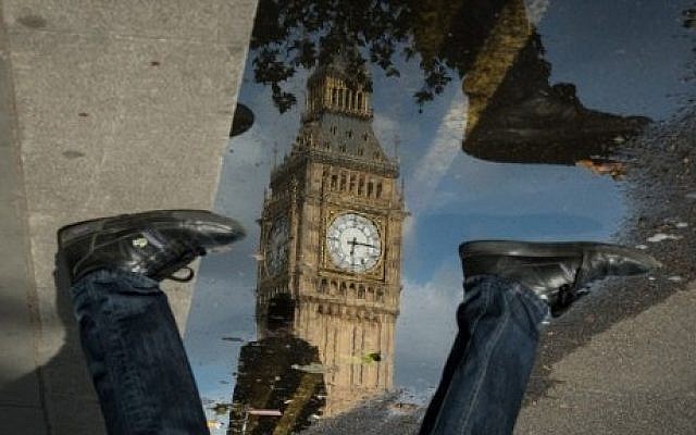 The Queen Elizabeth Tower (Big Ben) is reflected in a puddle as a man walks by in London, on 27 June 2016. (AFP PHOTO / Leon NEAL) The Queen Elizabeth Tower (Big Ben) is reflected in a puddle as a man walks by in London, on 27 June 2016. (AFP PHOTO / Leon NEAL)