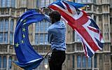 Illustrative: A man waves both a Union flag and a European flag together on College Green outside the UK Parliament on June 28, 2016. (Justin Tallis/AFP)