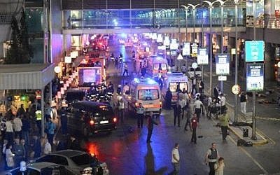 This picture obtained from the Ilhas News Agency shows ambulances and police setting up a perimeter, next to people lying on the ground (R), after two explosions followed by gunfire hit the Turkey's biggest airport of Ataturk in Istanbul, on June 28, 2016. (AFP / ILHAS NEWS AGENCY)