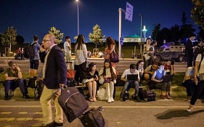 Passengers wait at Ataturk airport`s main entrance in Istanbul, on June 28, 2016, after two explosions followed by gunfire hit Turkey's largest airport, killing at least  36. (AFP / OZAN KOSE)