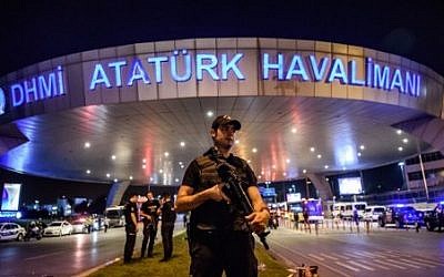 A Turkish riot police officer patrols Ataturk airport`s main entrance in Istanbul, on June 28, 2016, after explosions followed by gunfire hit Turkey's largest airport. (AFP/ OZAN KOSE)