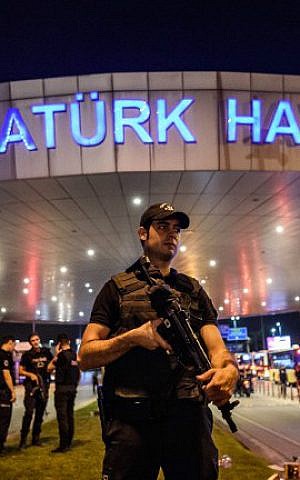 A Turkish riot police officer patrols Ataturk Airport's main entrance in Istanbul, on June 28, 2016. (Ozan Kose/AFP)
