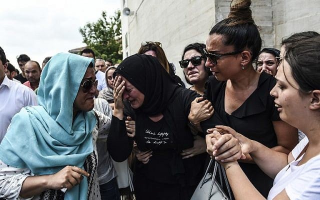 The daughter (C) of Siddik Turgan, a man who was killed in the June 28, 2016 airport attack, reacts as her father's coffin is carried nearby during his funeral ceremony on June 29, 2016 in Istanbul, a day after a suicide bombing and gun attack targeted Istanbul's airport, killing at least 41 people.(AFP PHOTO / BULENT KILIC)