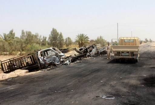 A member of the Iraqi government forces stands next to the charred vehicles on a road southwest of Fallujah after Iraqi forces airstrikes destroyed 260 vehicles carrying militants from the Islamic State group trying to flee after their defeat in Fallujah, June 29, 2016. (AFP/MOADH AL-DULAIMI) A member of the Iraqi government forces stands next to the charred vehicles on a road southwest of Fallujah after Iraqi forces airstrikes destroyed 260 vehicles carrying militants from the Islamic State group trying to flee after their defeat in Fallujah, June 29, 2016. (AFP/MOADH AL-DULAIMI)