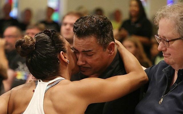 A man injured in the mass shooting at the Pulse Nightclub is hugged as he attends a memorial service at the Joy MCC Church for the victims of the terror attack on June 12, 2016 in Orlando, Florida. (Joe Raedle/Getty Images/AFP) A man injured in the mass shooting at the Pulse Nightclub is hugged as he attends a memorial service at the Joy MCC Church for the victims of the terror attack on June 12, 2016 in Orlando, Florida. (Joe Raedle/Getty Images/AFP)