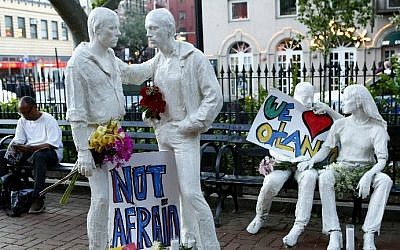 Tribute signs are placed on statues depicting homosexual couples in a park near the Stonewall Inn where a vigil was held following the massacre that occurred at a gay Orlando nightclub on June 12, 2016 in New York City. Monika Graff/Getty Images/AFP)