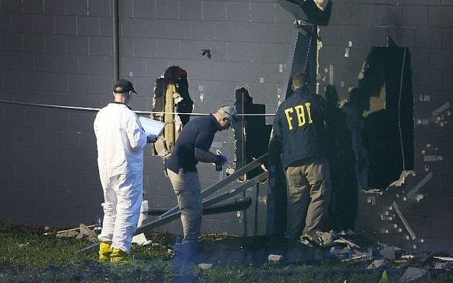 FBI agents investigate near the damaged rear wall of the Pulse Nightclub on June 12, 2016 in Orlando, Florida. (Joe Raedle/Getty Images/AFP)