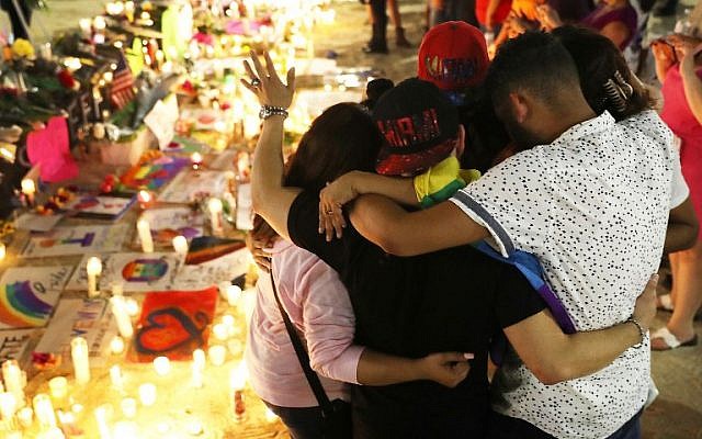 Mourners hug as they pay their respects at a memorial in front the Dr. Phillips Center for the Performing Arts for the victims of the Pulse gay nightclub shooting where Omar Mateen allegedly killed 49 people on June 13, 2016 in Orlando, Florida. (Joe Raedle/Getty Images/AFP) Mourners hug as they pay their respects at a memorial in front the Dr. Phillips Center for the Performing Arts for the victims of the Pulse gay nightclub shooting where Omar Mateen allegedly killed 49 people on June 13, 2016 in Orlando, Florida. (Joe Raedle/Getty Images/AFP)