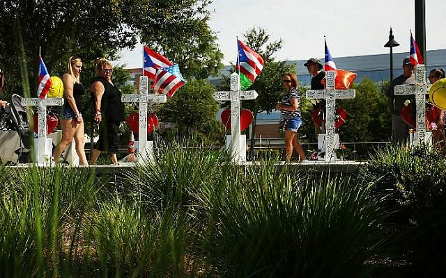 People visit a memorial down the road from the Pulse nightclub on June 18, 2016 in Orlando, Florida. (Spencer Platt/Getty Images/AFP) People visit a memorial down the road from the Pulse nightclub on June 18, 2016 in Orlando, Florida. (Spencer Platt/Getty Images/AFP)