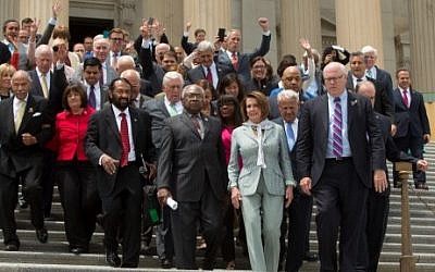 House members led by Minority Leader Nancy Pelosi (D-CA) and James Clyburn (D-SC), walk down the East Front of the U.S. Capitol building to speak with supporters on June 23, 2016. (Allison Shelley/Getty Images/AFP)