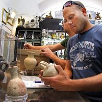 Inspectors of the IAA’s Unit for the Prevention of Antiquities Robbery inspect old jugs during a raid on a souvenir store in Jerusalem's upscale Mamilla Mall on June 15, 2016. ( Courtesy: Israel Antiquities Authority) Inspectors of the IAA’s Unit for the Prevention of Antiquities Robbery inspect old jugs during a raid on a souvenir store in Jerusalem's upscale Mamilla Mall on June 15, 2016. ( Courtesy: Israel Antiquities Authority)