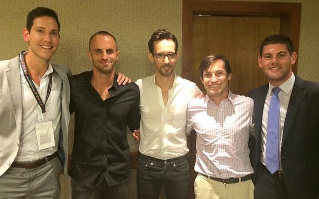 Josh Mann (right) poses with fellow JFNA LGBT mission participants Kyle Levine and David Rak, along with Israeli singer Ivri Lider (center) and Israeli media personality Aviad Kisos (second from left). Tel Aviv Hilton, May 31, 2016. (Renee Ghert-Zand/Times of Israel)