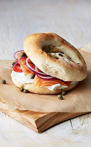 A bialy with lox, cream cheese, onions, and capers from Kossar's. (Courtesy Kossar's Bagels and Bialys) A bialy with lox, cream cheese, onions, and capers from Kossar's. (Courtesy Kossar's Bagels and Bialys)