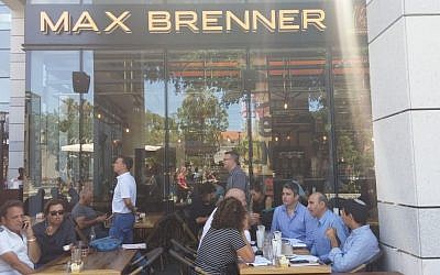 Customers sit at the Max Brenner cafe on June 9, 2016 where a day before, four people were killed in a shooting spree by two Palestinian cousins. (Ricky Ben-David)