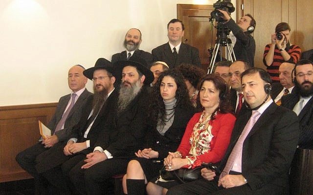 Lev Leviev, front right, listening to a ceremony marking the opening of a Chabad center in Vienna, is seated next to his wife and daughter. One of Russia’s chief rabbis, Berel Lazar, is second from left, Feb. 18, 2007. (Dinah A. Spritzer via JTA) Lev Leviev, front right, listening to a ceremony marking the opening of a Chabad center in Vienna, is seated next to his wife and daughter. One of Russia’s chief rabbis, Berel Lazar, is second from left, Feb. 18, 2007. (Dinah A. Spritzer via JTA)
